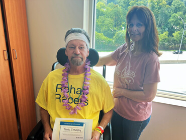 Dennis Murphy celebrates completing rehab with his wife.