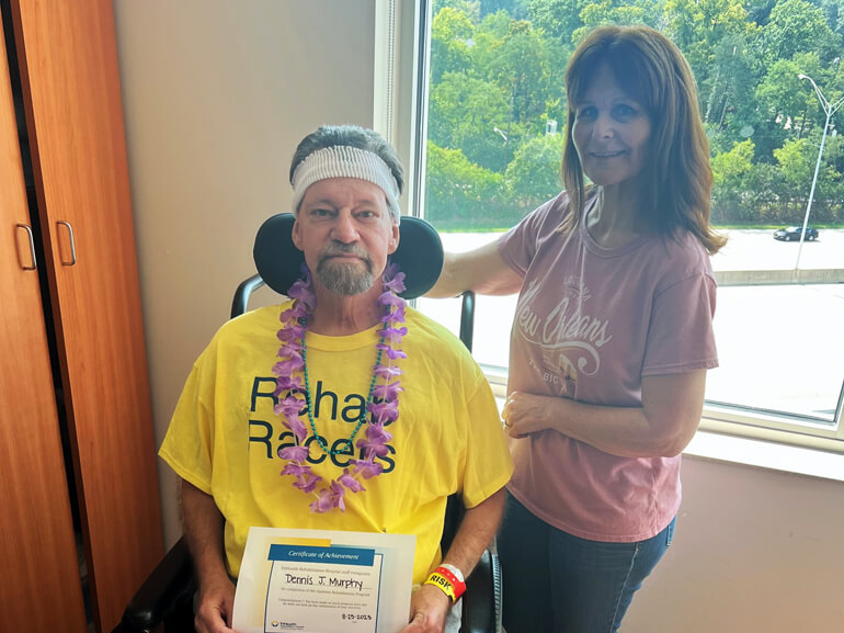 Dennis Murphy celebrates completing rehab with his wife.